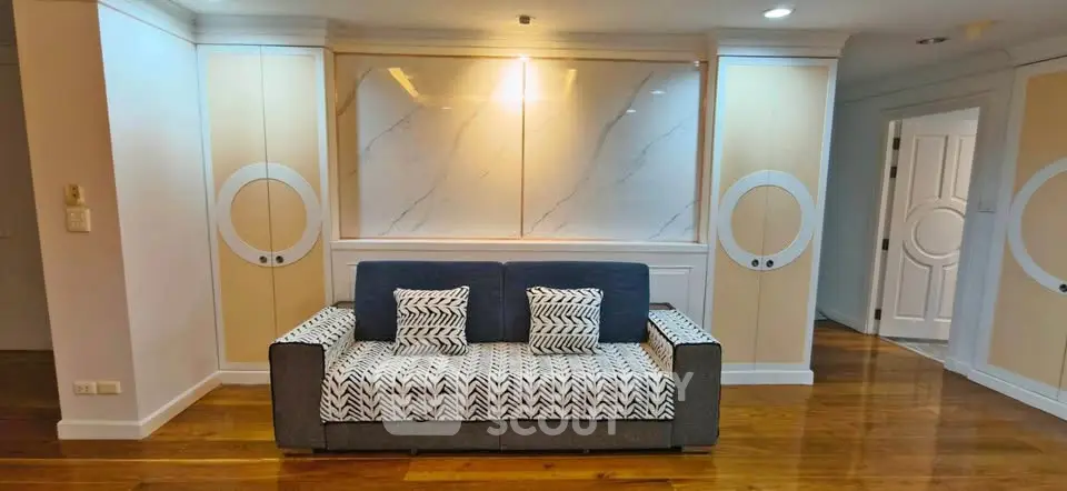 Stylish living room with modern sofa and elegant wall design in a contemporary apartment.