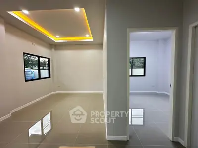 Modern interior with sleek tile flooring and recessed lighting in a spacious living area.