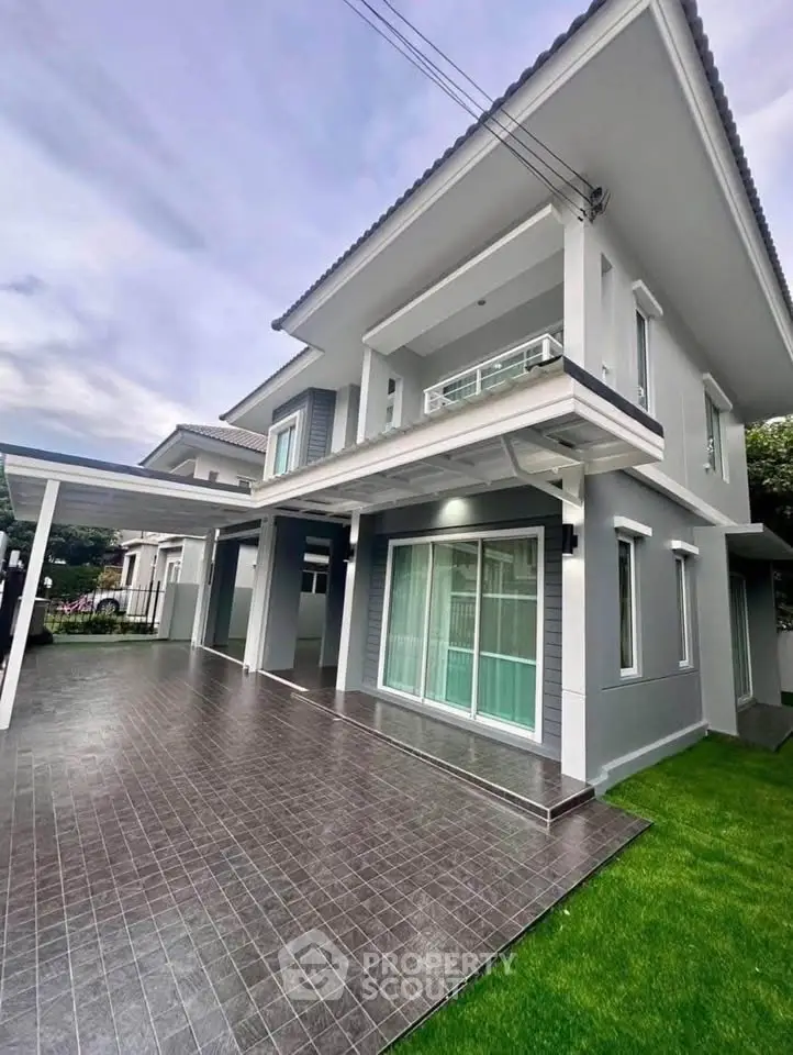 Modern two-story house with spacious driveway and lush green lawn