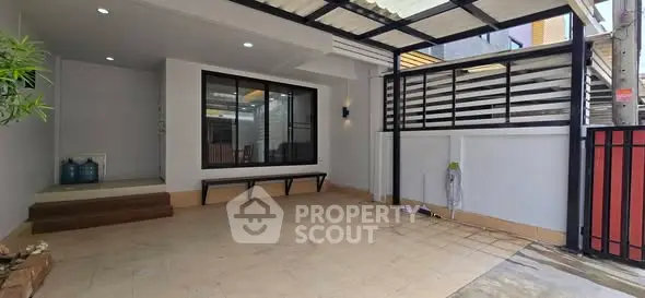 Spacious covered parking area with modern design and ample natural light.