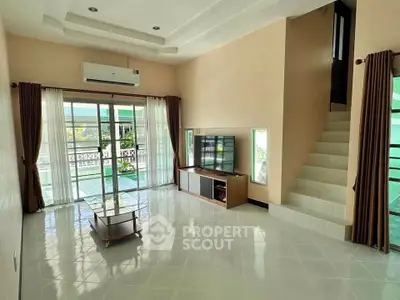 Spacious living room with modern decor and natural light