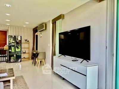 Spacious modern living room with large TV and stylish decor