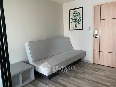 Modern living room with sleek sofa and wooden flooring in a stylish apartment.