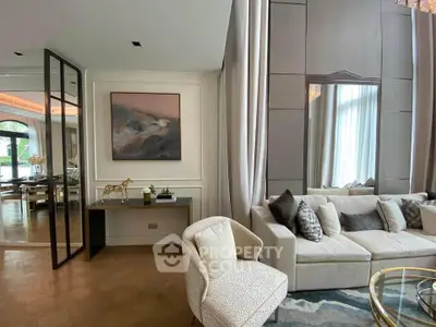 Luxurious living room with elegant decor, plush sofa, and large window for natural light.