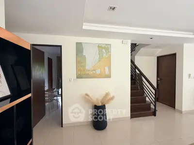 Modern interior with staircase and stylish decor in a spacious living area.