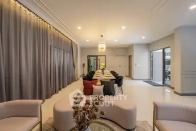Luxurious open-plan living and dining area with elegant decor and ample natural light.