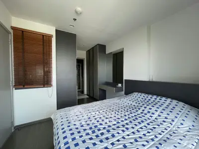 Modern bedroom with stylish decor and ample natural light