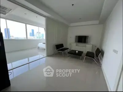 Modern living room with sleek furniture and city view, perfect for urban living.