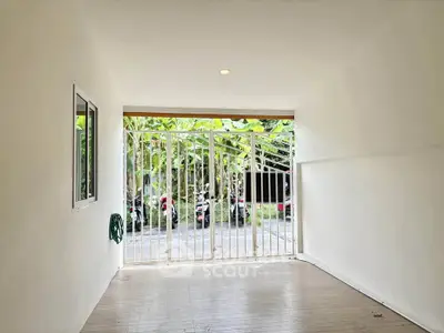 Spacious garage with white walls and gated entrance, ideal for secure parking or storage.
