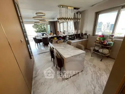 Luxurious open-layout kitchen with marble dining table and city view