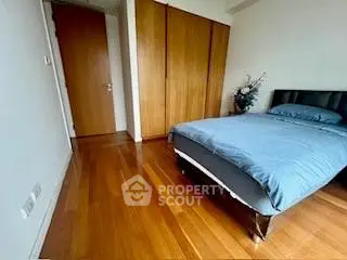 Spacious bedroom with wooden flooring and modern decor