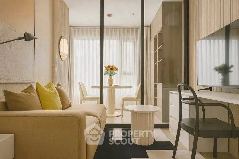 Modern living room with stylish decor and natural light, featuring a cozy sofa and dining area.