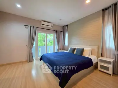 Spacious bedroom with large windows and modern decor