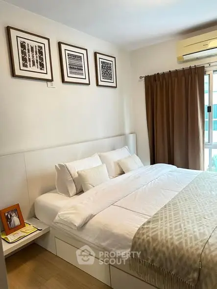 Cozy bedroom with modern decor and large window for natural light