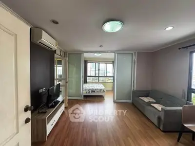 Spacious living room with modern decor and large windows offering natural light.