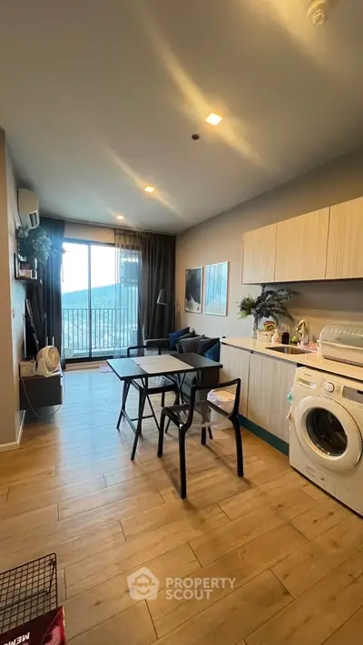 Modern living room with open kitchen and balcony view