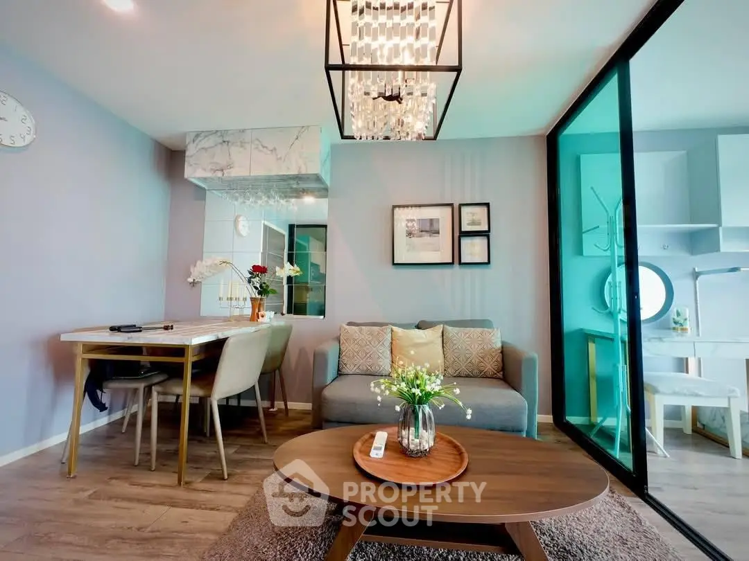 Modern living room with elegant decor and open layout, featuring a cozy dining area and stylish lighting.