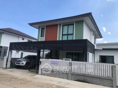 Modern two-story house with carport and stylish facade in suburban neighborhood.