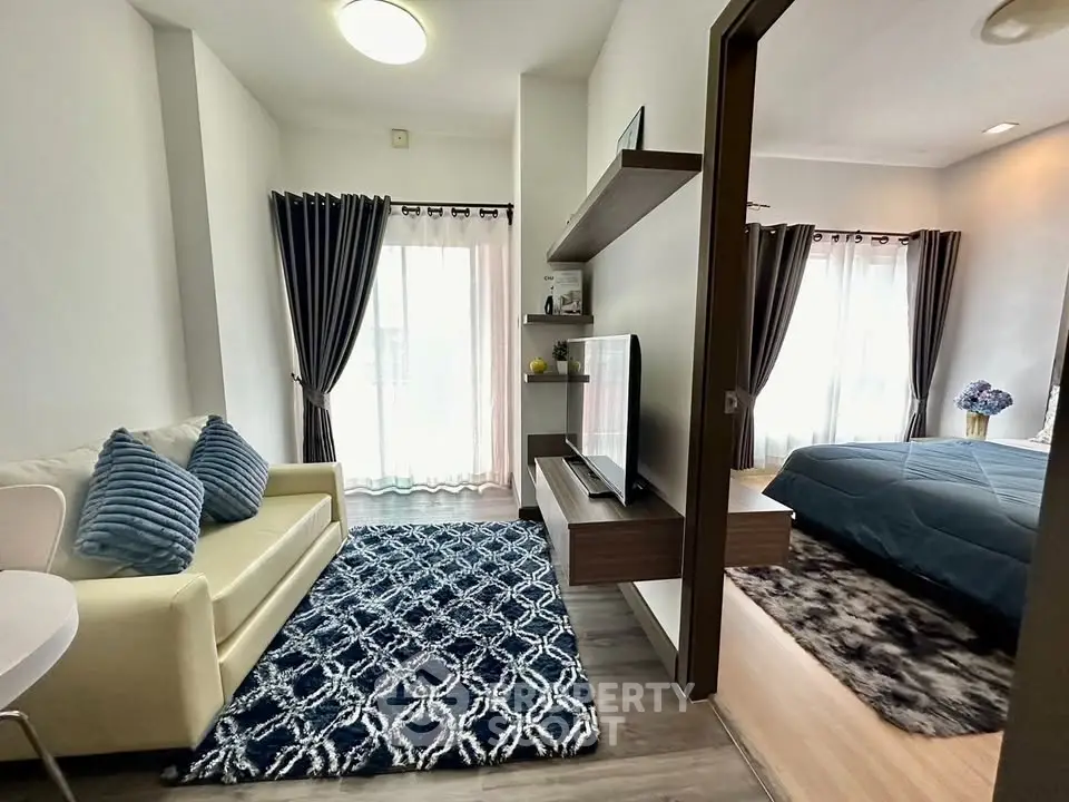 Modern studio apartment with stylish living area and cozy bedroom, featuring elegant decor and natural light.