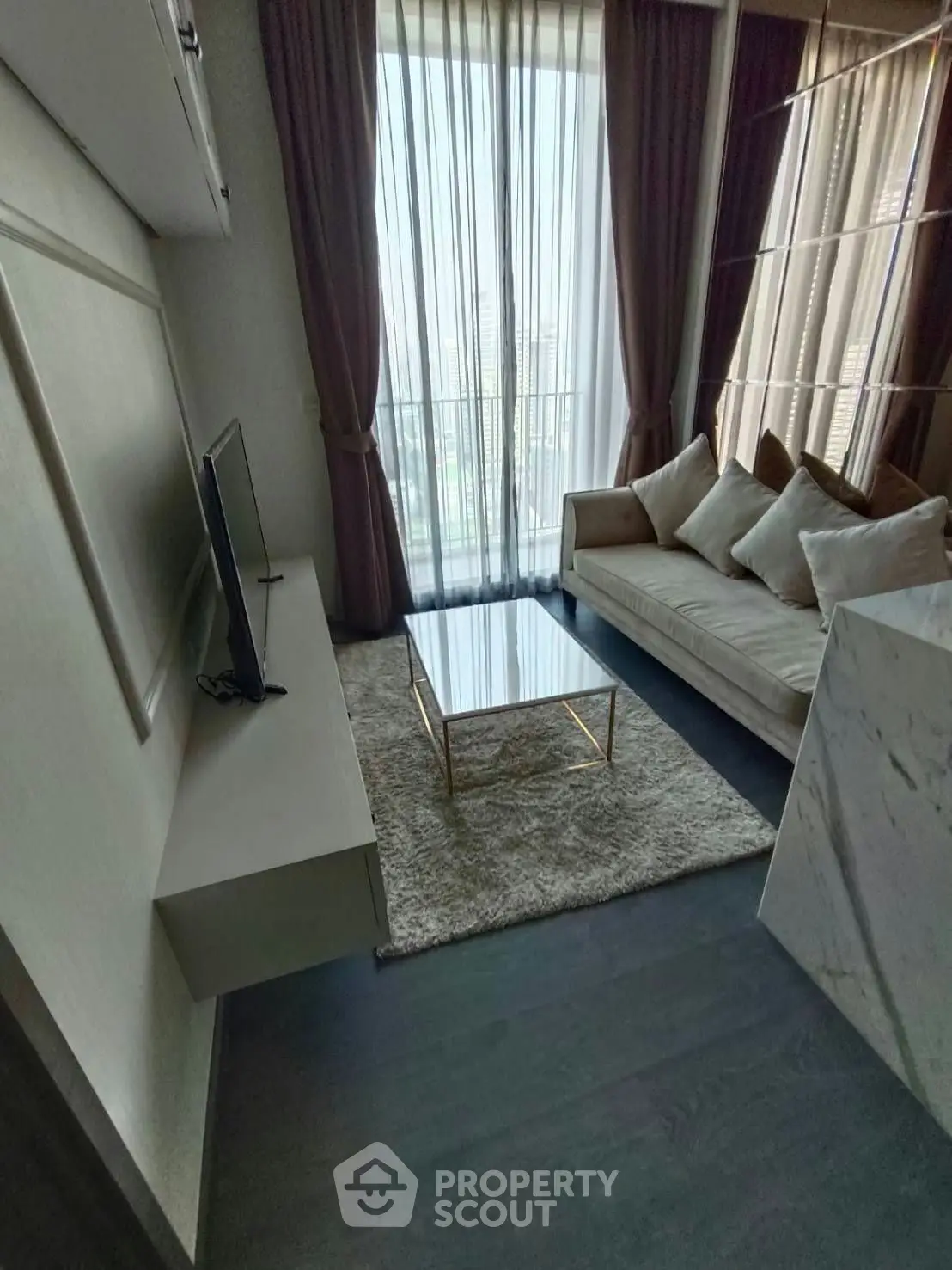 Modern living room with elegant decor and floor-to-ceiling windows