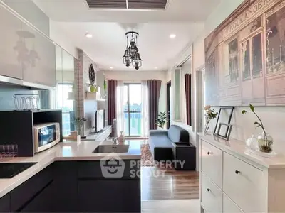 Modern open-layout kitchen and living room with stylish decor and natural light.