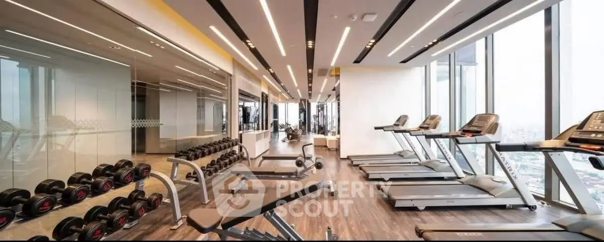 Luxurious high-rise gym with panoramic city views and modern equipment.