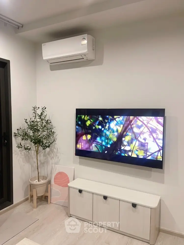 Modern living room with wall-mounted TV and air conditioning