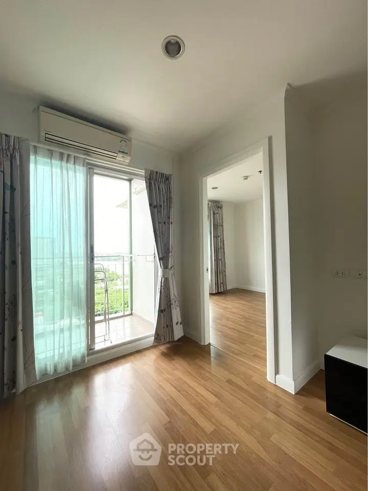 Bright and airy apartment with balcony and wooden flooring, perfect for modern living.