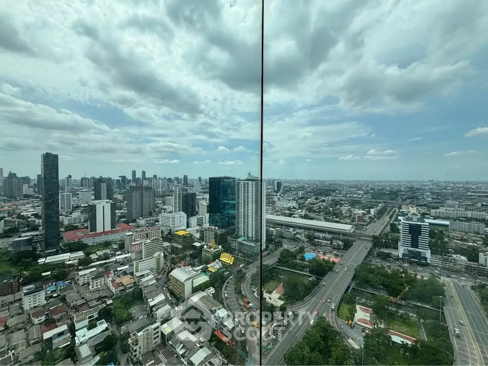 Stunning panoramic city view from high-rise building, showcasing urban skyline and expansive horizon.