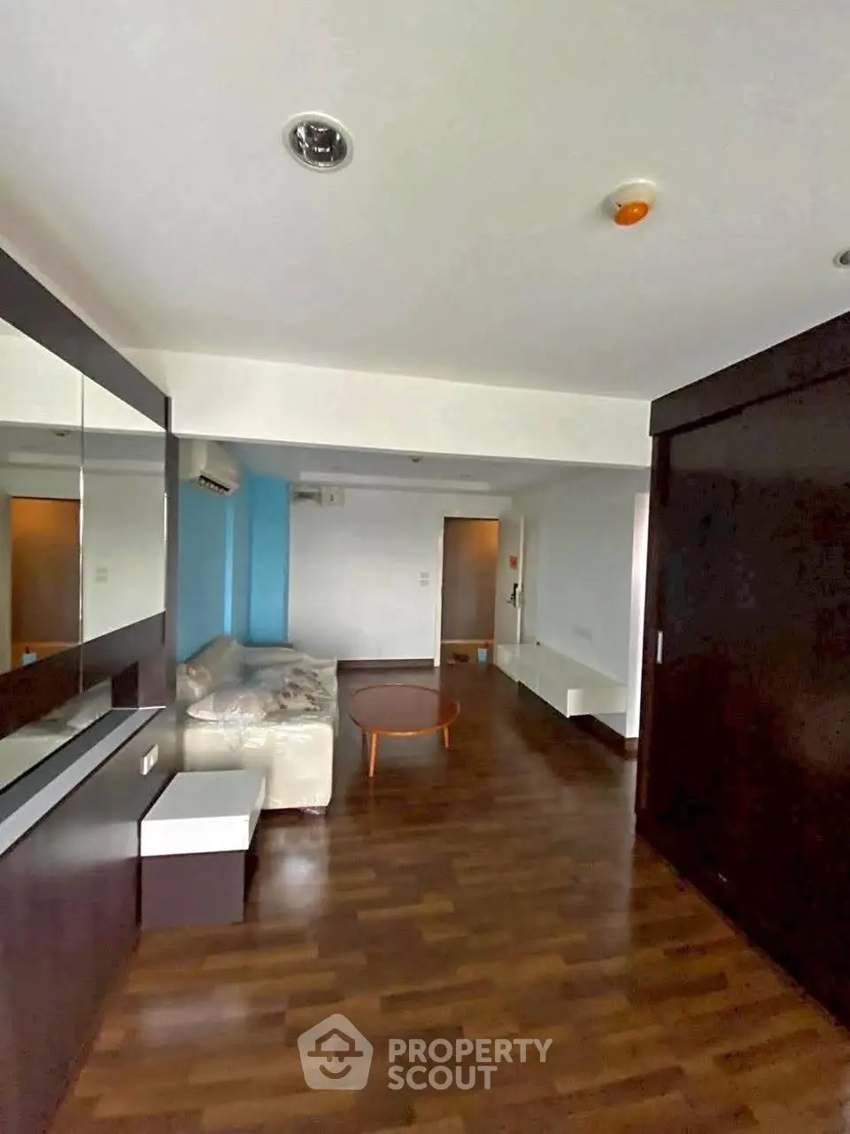 Spacious living room with modern decor and wooden flooring