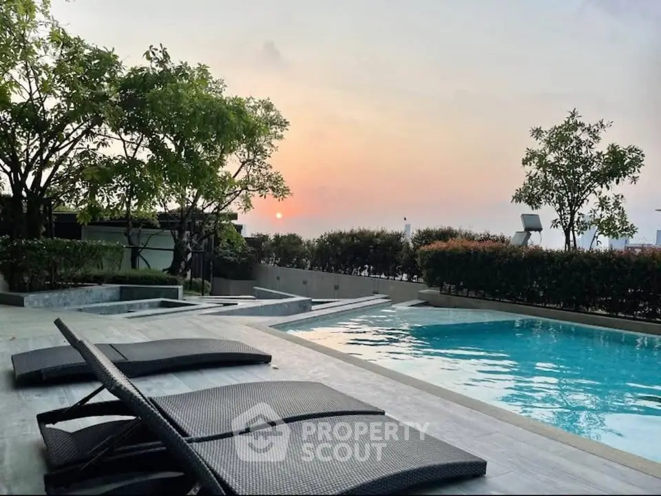 Luxurious poolside area with sunset view, perfect for relaxation and leisure in a serene environment.