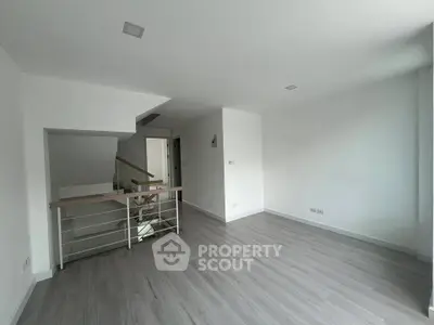 Spacious modern living room with sleek flooring and minimalist design, perfect for contemporary living.
