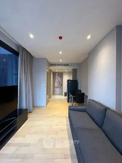 Modern living room with sleek design, featuring a comfortable sofa and stylish decor in a contemporary apartment.