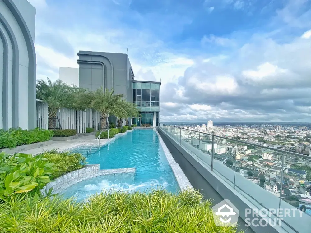 Stunning rooftop pool with panoramic city views and lush greenery