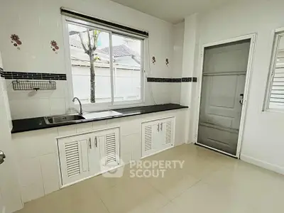 Spacious kitchen with sleek countertops and ample natural light