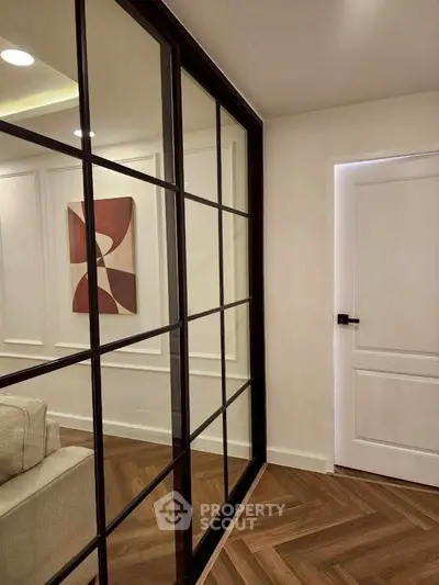 Modern interior with glass partition and stylish wooden flooring