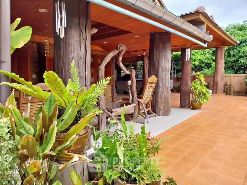 Charming rustic patio with wooden pillars and lush greenery, perfect for outdoor relaxation.