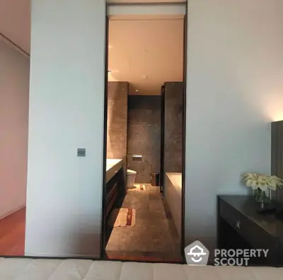 Elegant bathroom with modern finishes, featuring a spacious layout, sleek vanity, and a warm, inviting ambiance perfect for relaxation.