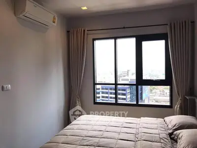 Modern bedroom with city view and air conditioning in high-rise apartment.