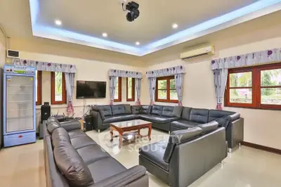 Spacious living room with modern leather sofas and large windows