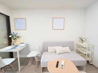 Chic modern living room with cozy sofa and dining area, perfect for urban living.
