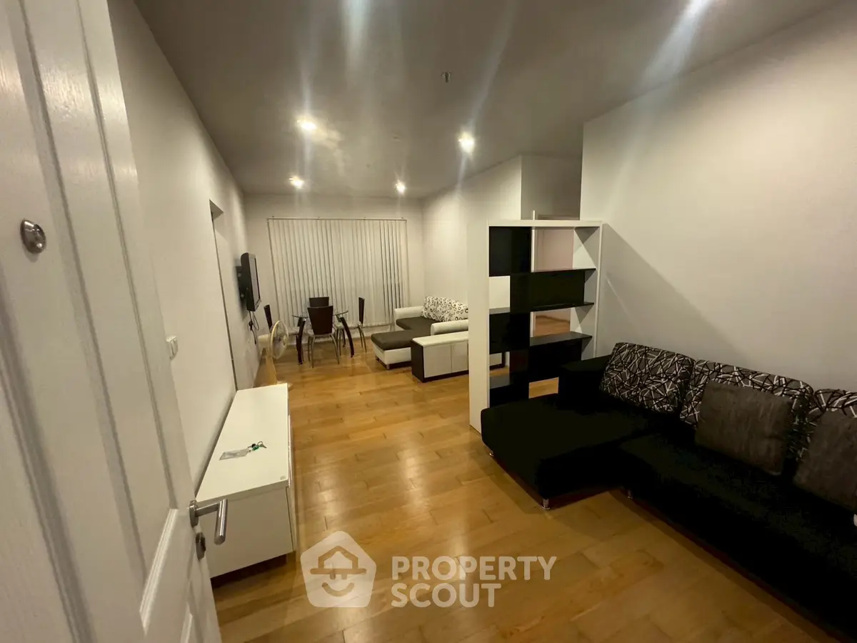 Spacious living room with modern furniture and wooden flooring