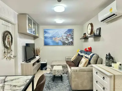 Cozy living room with modern decor and wall-mounted TV, perfect for relaxation and entertainment.