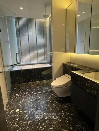 Luxurious modern bathroom with sleek black marble and glass shower