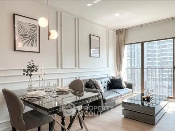 Stylish modern living room with elegant dining area and large windows offering city views.