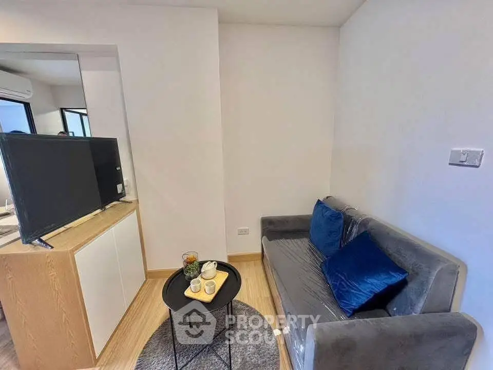 Cozy living room with modern decor and comfortable seating in a stylish apartment.