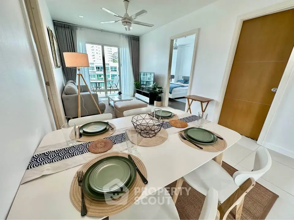 Modern dining and living area with stylish decor and natural light in a contemporary apartment.