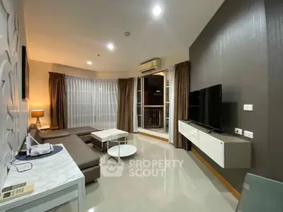 Modern living room with sleek furniture and large windows in a stylish apartment.