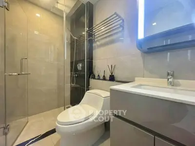 Modern bathroom with sleek fixtures and glass shower enclosure
