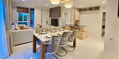 Modern open-plan living and dining area with elegant decor and natural light.